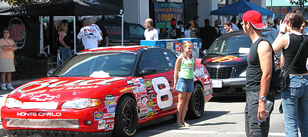 Wide shot of booth & Bud car.