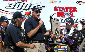 Jim Lee gives Biffle his trophy.