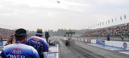 Dragster launches at start line.