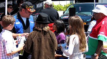 Crowding around Unc & his car.