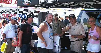 Unc signs autographs at Cool Patrol booth.