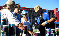 Unc signs autographs at Cool Patrol booth.