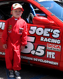 The kid is ready to race the car.