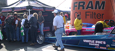Wide shot of Arrow booth and race cars.