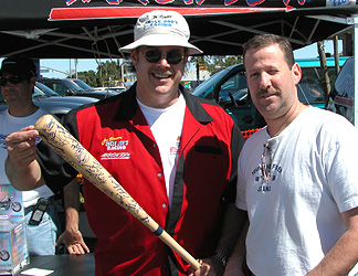 Signing a baseball bat.